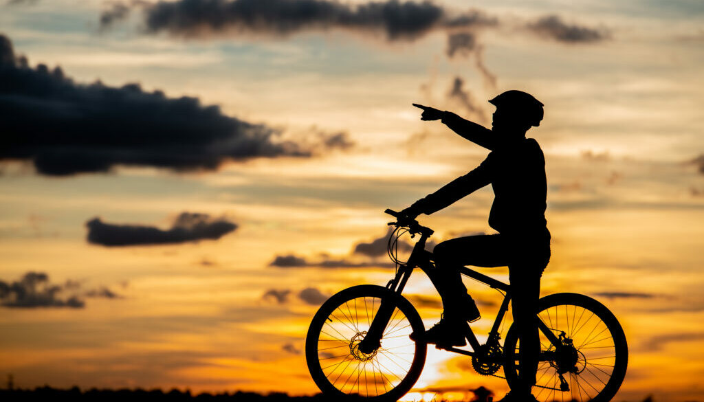 Cyclist resting silhouette at sunset. active outdoor sport conce